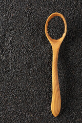 Poster - Black sesame seeds and wooden spoon.