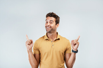 Sticker - Excited, mockup and man pointing in studio isolated on a gray background. Smile, hand gesture and happy person advertising, marketing offer and approve of commercial copy space for promotion or deal