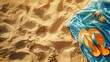 © chutikan - Close-up of flip flops and towel lying on the sandy beach, quiet and relaxing.