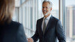 © Carmen - Middle age Caucasian businessman speaking with colleagues in office setting, copy space