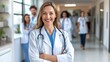 © Anna - A doctor stands confidently with a stethoscope, smiling as colleagues walk through a well-lit hospital corridor, showcasing teamwork and professionalism in healthcare