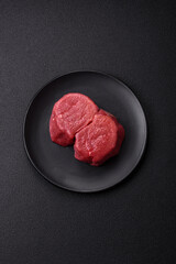 Wall Mural - Fresh juicy raw beef medallions with salt and spices