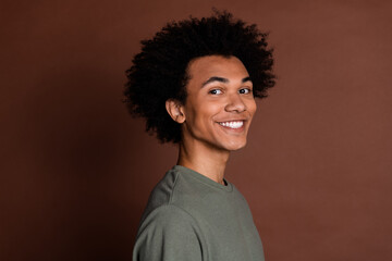 Canvas Print - Portrait photo of young funky guy with curly haircut wearing gray casual t shirt toothy beaming smiling isolated on brown color background