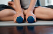 © HockleyM2/peopleimages.com - Hands, home and woman with dumbbells, exercise and weights for fitness, wellness and break. Apartment, closeup and person with equipment, workout and training for balance, healthy and challenge