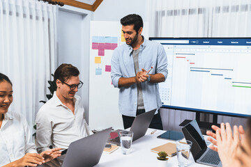 Aufkleber - Project manager communicate and collaborate with team using project management software display on monitor, tracking progress of project task and making schedule plan at meeting table. Prudent