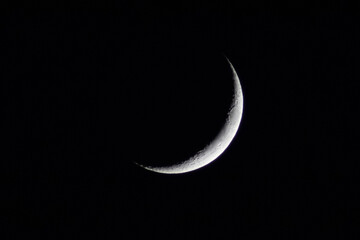 crescent moon in the night sky,detailed,crescent moon on black,ramadan and eid theme.