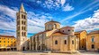 © Four888 - Historic Church of St. Donatus in Zadar, Croatia, showcasing its stunning Romanesque architecture, bell tower, and ornate stone carvings against a blue sky backdrop.