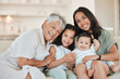 © peopleimages.com - Mother, grandmother and children with portrait on sofa for bonding, happy memory and support with hugging. People, family love and kids on couch in living room with smile, embrace and generations