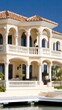 © lililia - A luxurious waterfront property showcases a sleek yacht docked nearby under a clear blue sky , creating a peaceful coastal ambiance