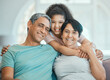 © Haas/peopleimages.com - Grandparents, child and hug in portrait on couch with happiness, love and support in home. Family, care and smile together in living room, apartment or relax on sofa in house with senior couple
