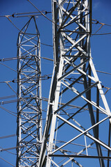 Wall Mural - High voltage electricity towers under blue sky