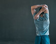 © Haas/peopleimages.com - Stretching, fitness and back of man for exercise, training and warm up for athlete workout on gray background. Health, sports and person with mockup space for wellness, performance and flexibility