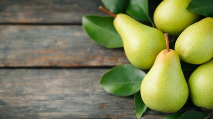 Wall Mural - Fresh green pears nestled among vibrant leaves on a rustic wooden table