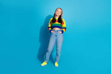 Poster - Full length photo of lovely young lady hands pockets posing dressed stylish striped garment isolated on blue color background