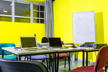 Empty office with laptops and documents on the table