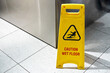 © Kate - A yellow floor folding sign that draws attention to a freshly washed slippery floor.