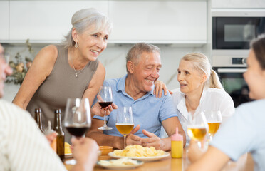 Wall Mural - Happy elderly friends spending free time together in kitchen of a nursing home - having lunch and chatting