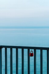 Canvas Print -   Ocean view from balcony, red purse on railing