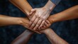 © Jay Koppelman - A close-up of diverse multicultural hands stacked together in a unity gesture, symbolizing teamwork, solidarity, and strength in diversity while celebrating community through DEI initiatives