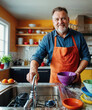 © aninna - middle-aged man in a kitchen with a smile on his face is busy cleaning the kitchen