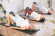 © JackF - Group of elderly people in sportswear practice pilates with soft ball on mat in fitness studio
