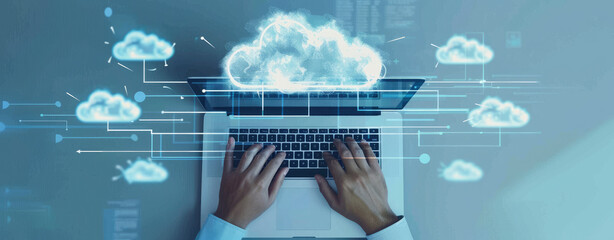 Canvas Print - An overhead view of hands typing on an open laptop, with cloud icons and data connections floating above the screen