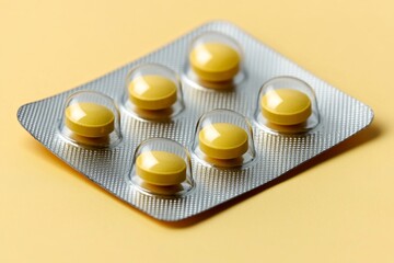 Sticker - Close up of shiny yellow tablets arranged in a blister pack on a yellow background symbolizing health precision and care in a minimalist and clean design