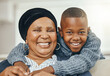 © Flashizzle/peopleimages.com - House, grandmother and boy with love, hug and cheerful with embrace, bonding together and happiness. Black family, apartment and senior woman with grandchild, portrait and funny with joy and smile