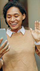 Wall Mural - A Cheerful Young Woman Video Calling with Her Smartphone in a Comfortable Setting at Home