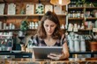 © kitipol - Woman with tablet making online purchase, professional working remotely, cafe background