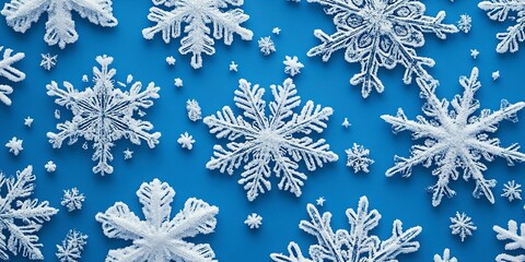 Wall Mural - Close-up of intricate snowflake patterns on a blue background, great for winter or cold weather-themed designs