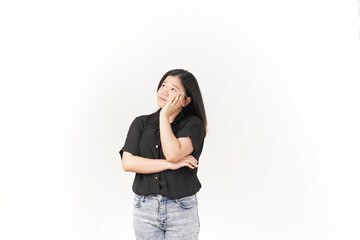 Wall Mural - Young Asian woman doing thinking gesture wearing Black t-shirt and jeans isolated on white background