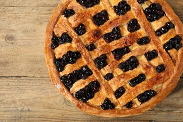 Wall Mural - Tasty homemade pie with blueberries on wooden table, top view