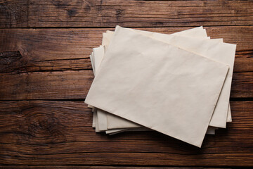 Sticker - Old letter envelopes on wooden table, top view