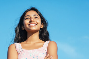 Wall Mural - Indian woman smile enjoying sun during summer vacation, mental health