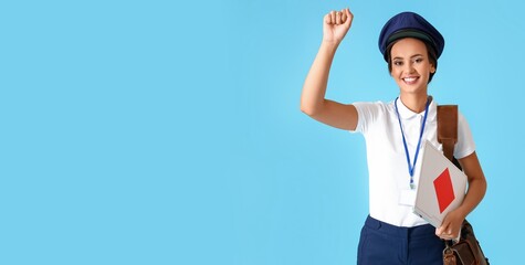 Wall Mural - Young postwoman with envelopes on light blue background with space for text