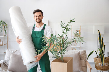 Wall Mural - Male worker with roll of bubble wrap in room