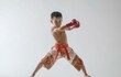 © LimeSky - Young boy training in Thai boxing against white backdrop Martial arts practice in motion capturing movement evolution Emphasis on youth sport and Asian culture