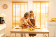 © CandyRetriever  - Happy Asian family enjoy and fun indoor healthy lifestyle cooking and having dinner together at home. Senior mature mother teaching adult daughter making vegan food vegetables salad in the kitchen