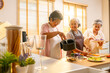 © CandyRetriever  - Group of Happy Asian senior women having dinner together at home. Elderly woman friends enjoy healthy lifestyle cooking and making vegan food vegetables salad with using air fryer in the kitchen.