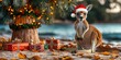 © Ross - Kangaroo in Santa Hat Next to Decorated Christmas Tree with Gifts on Beach Surrounded by Autumn Leaves in Beautiful Sunset