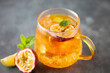 © murziknata - Fruit ice tea. Refreshing summer drink with syrup, passion fruit, lime, mint and ice. Glass with cold and healthy beverage