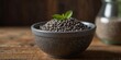 © Ta Sher - Chia seeds in a bowl displayed on a wooden surface with a blank area for additional content copy space image.