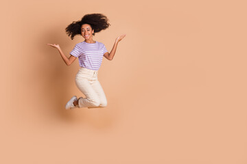 Sticker - Full length portrait of pretty young woman jump hold empty space wear t-shirt isolated on beige color background