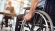 © Natalia - A hand gripping the wheel of a wheelchair. AI.