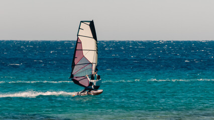 Poster - young surfer girl rides a sail in the Red Sea in Egypt Dahab