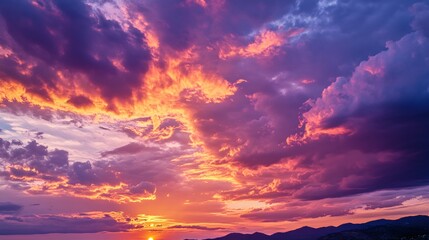 a sunset sky deep orange and pink hues blending with darker purples as the day turns to night.