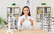 © Studio Romantic - Portrait of a happy female ophthalmologist doctor or nurse holding eyeglasses in hospital office. Role of healthcare professionals in providing eye care and medical support to patients.