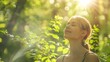 © Farid - Relaxed woman breathing fresh air in a green forest.