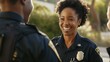 © VK Studio - A smiling police officer engages warmly in conversation under verdant, sunlit surroundings, radiating approachability and trust.
